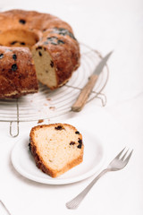 Slice of traditional German or Austrian Gugelhupf or Kouglof from Alsace, France, a round bundt cake with raisins made of brioche yeast sponge or sweet bread dough and dusted with sugar