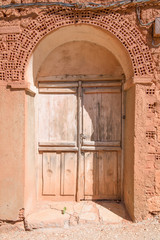 Fototapeta na wymiar ancient door of house built with bricks and adobe, in old town of Ayllon village, Segovia, Spain, Europe
