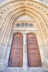 Obraz premium wooden door of landmark cathedral of San Antolin, gothic monument from fourteenth century, in Palencia city, Castile Leon, Spain, Europe