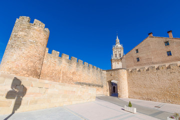 exterior medieval wall of Burgo de Osma town, with public street and tower of cathedral, landmark and monument from thirteenth century, in Soria, Spain, Europe