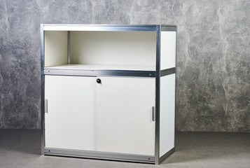 White glass showcase stand against gray textured wall background. International Exhibition...