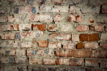 the texture of an old brickwork with remnants of plaster