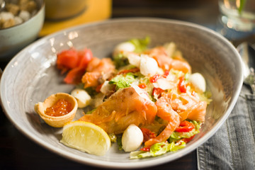 salad with salmon, caviar, vegetables, herbs and lemon share, salad with fish and vegetables