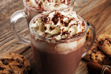 Hot chocolate cocoa with whipped cream on table.