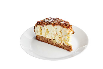 Yoghurt cake with ananas on a white plate and white background. Isolated.