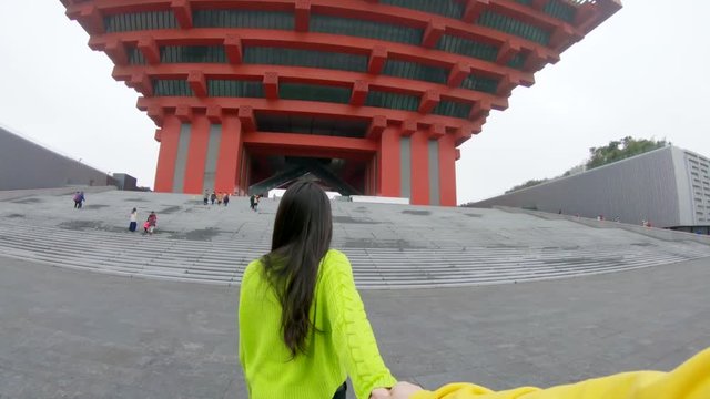 Couple hold hands near China Pavilion, POV