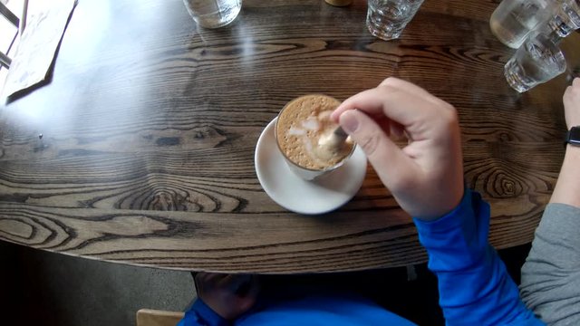 POV, drinking latte in cafe