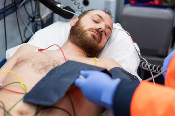 Emergency doctor checking blood pressure of a patient in the ambulance © herraez