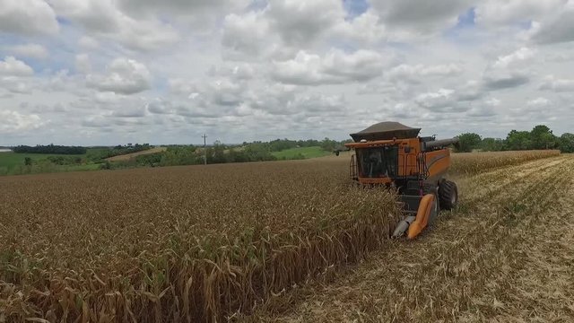  Tractor harvesting large aerial side farm