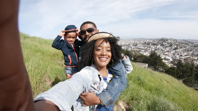Family takes selfie on San Francisco hillside, POV