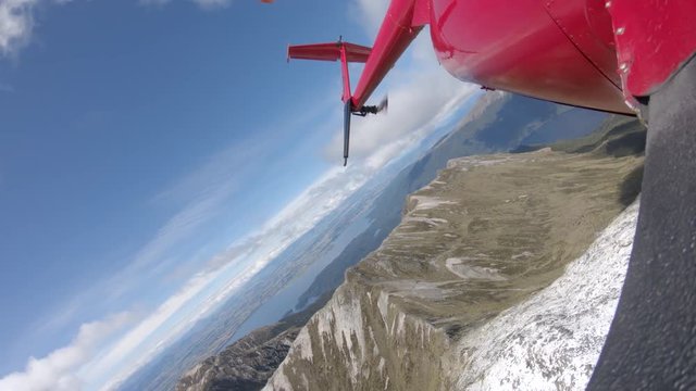 New Zealand helicopter flies over snowy mountain, POV