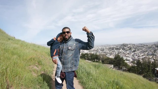 Father and son poses on San Francisco hillside, POV
