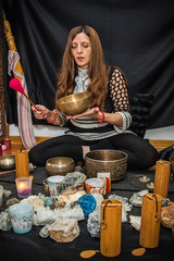 Woman playing a singing bowls also known as Tibetan Singing Bowls, Himalayan bowls. Tibetan Singing Bowls Treatment. Tibetan sound massage.