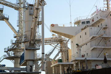 Port grain elevator close up. Industrial sea trading port bulk cargo zone grain terminal