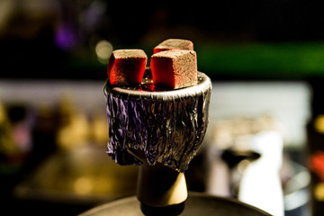 Hot coals for Smoking hookah. Bowl with tobacco and coal. 