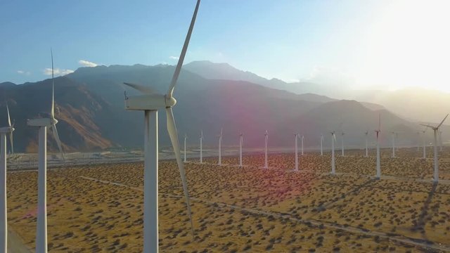 Energy Conservation - Dynamic Aerial Near-death Drone Shot of Wind Trubine Farm