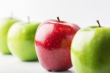 Row of green apples on green background