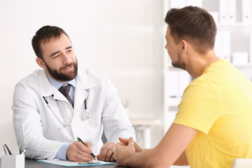 Doctor consulting male patient in clinic
