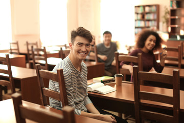Fototapeta premium Group of students studying in library
