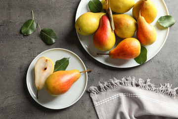 Flat lay composition with ripe pears on grey background