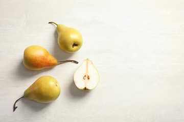 Fototapeta na wymiar Flat lay composition with ripe pears on light background. Space for text