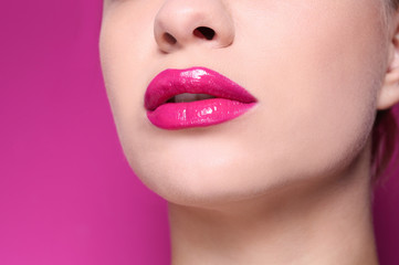 Obraz premium Beautiful young woman with perfect lips makeup on color background, closeup