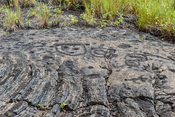 Petroglyphs in lava rock at Pu'uloa along Chain of Craters road, in volcano National Park on the island of Hawaii. Carvings are 400-700 years old.