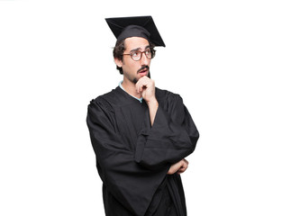 graduate bearded man with a dissenting, serious, stern expression, with thumbs down in disapproval.