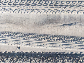 More tyre tracks impression in rippling sand	