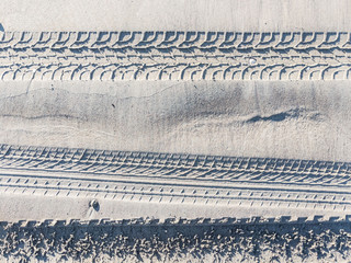 More tyre tracks impression in rippling sand	