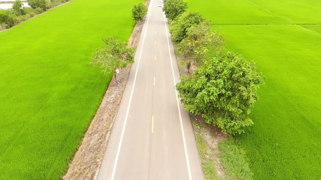 Aerial shot / Cars that run on rural roads outside the city.