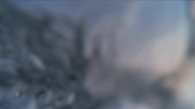 POV, person paddles surfboard in slow motion