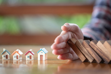 Business woman covering home with hands, insurance concept