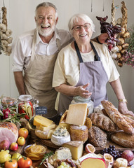 Senior couple working at a farm shop - obrazy, fototapety, plakaty