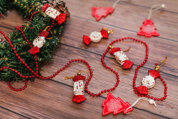Close up Christmas wreath with bumps and red decor on wooden table. Copy space for text or design.
