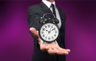 Businessman with clock in time concept on