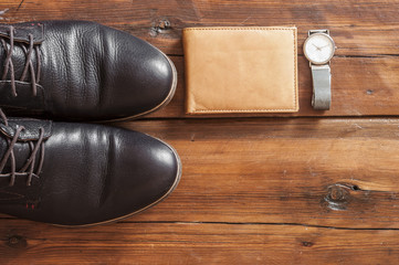 Top view of essentials for modern person. Men accessories on wooden background