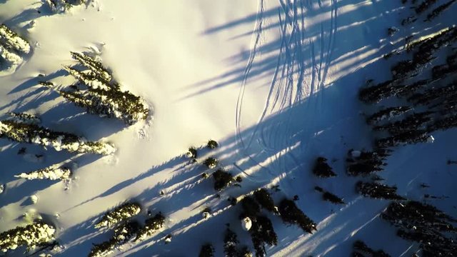 Aerial, skiers in British Columbia at sunset