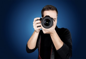 Male Photographer with Camera on grey background