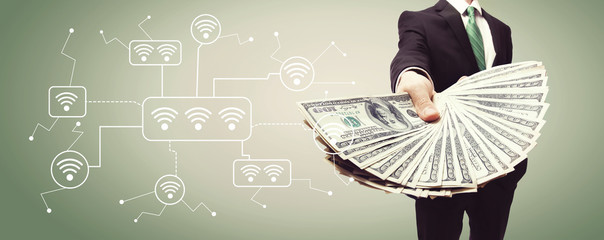 Wifi with business man displaying a spread of cash