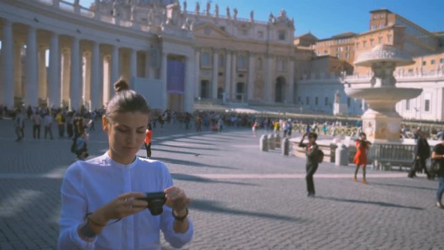 girl does a photo on the central square of the Vatican Piazza San Pietro