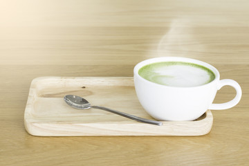 Hot Green tea mail cup,Matcha latte and beans on wooden table, in the morning