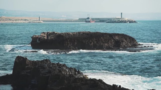 Sea and waves scene near the city of Beirut with a small island in the middle.