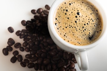 Closeup of cup of espresso and coffee beans