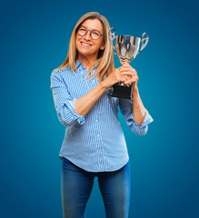 senior beautiful woman with a trophy
