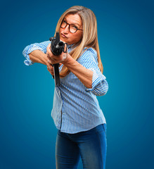 senior beautiful woman with a rifle. conflict concept