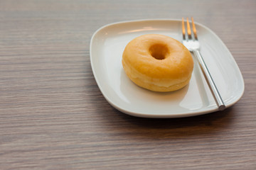 Plain donuts on wooden table