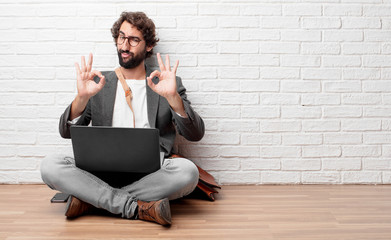 young man sitting on the floor making an 