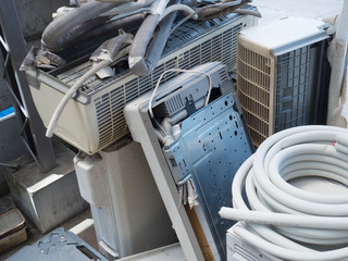 Disposing or collecting and recycling old air conditioners or HVACs. piled old AC units.
