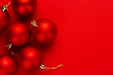 Christmas tree decoration balls on red background with copy space